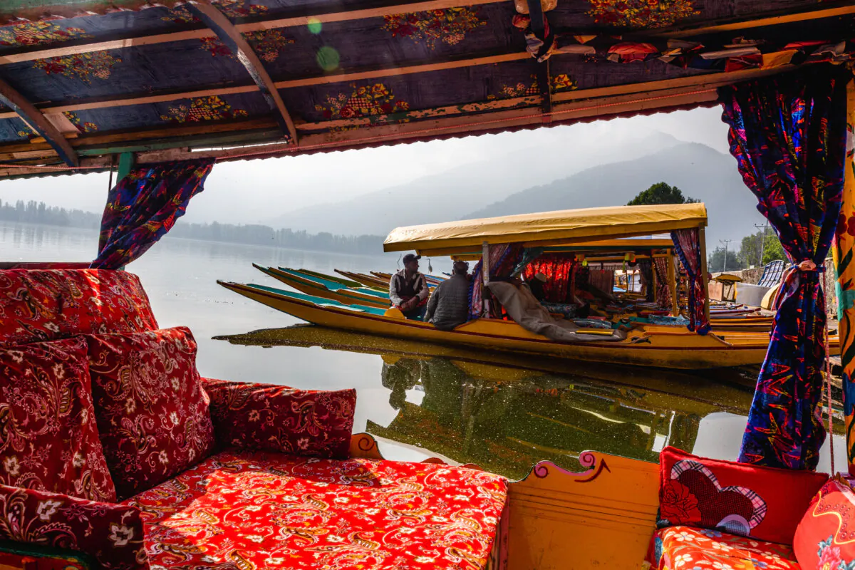 Kashmiri shikara boatmen chat as their boats are moored to the bank of Dal lake in Srinagar, India, on May 11, 2025. (Yawar Nazir/Getty Images)