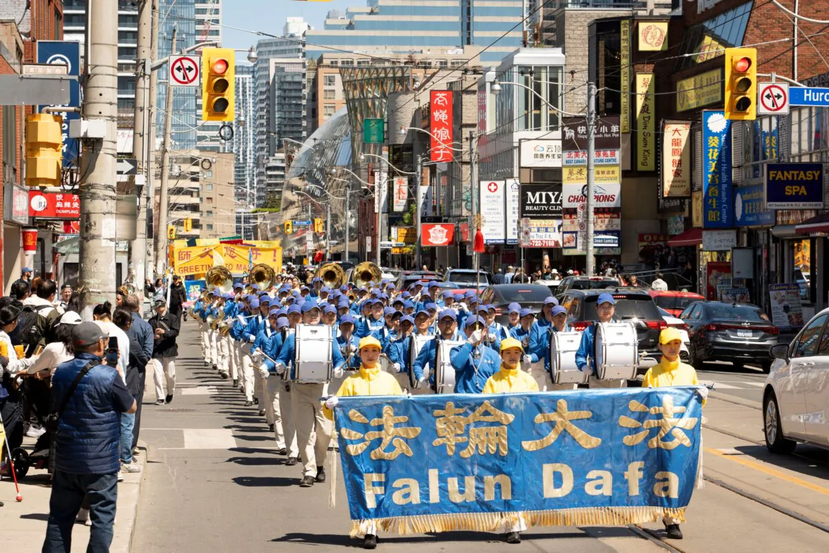 Falun Dafa practitioners hold a parade to celebrate World Falun Dafa Day in downtown Toronto on May 11, 2025. (Evan Ning/The Epoch Times)