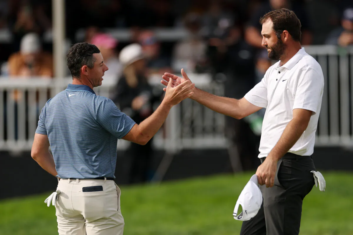Rory McIlroy of Northern Ireland (L) and Scottie Scheffler of the United States shake hands on the 18th green after their round during the final round of The Genesis Invitational 2025 at Torrey Pines Golf Course in La Jolla, California on February 16, 2025. (Harry How/Getty Images)