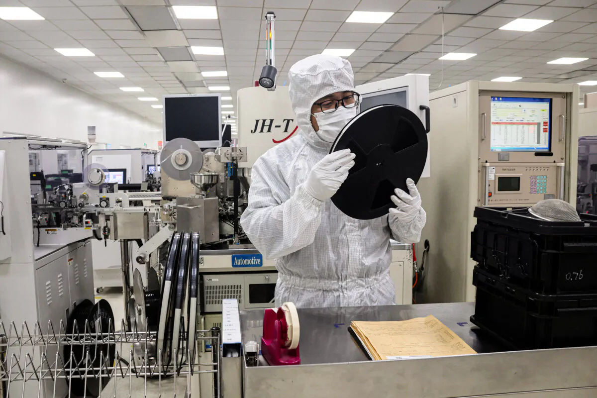 An employee inspects semiconductor chips at a factory in Binzhou, Shandong Province, China, on Jan. 15, 2025. (STR/AFP via Getty Images)