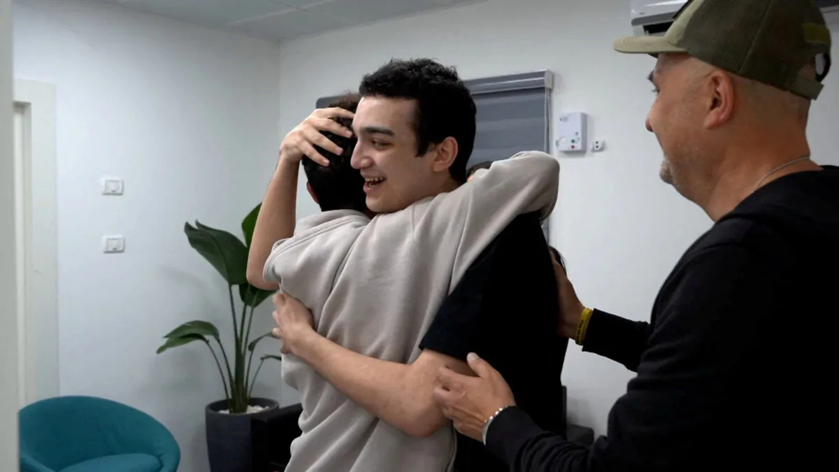 Edan Alexander, who has been released from captivity by Hamas, after he had been kidnapped during the deadly October 7, 2023 attack on Israel, embraces his brother as he reunites with his family in Reim, southern Israel, before flying to Tel Aviv, on May 12, 2025. (GPO/Handout via Reuters)