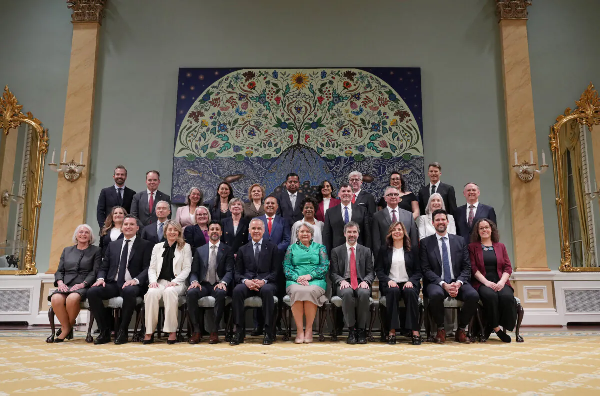 Prime Minister Mark Carney (front 5th L) poses with members of the newly sworn-in Liberal cabinet following a ceremony at Rideau Hall in Ottawa on May 13, 2025. (The Canadian Press/Christinne Muschi)