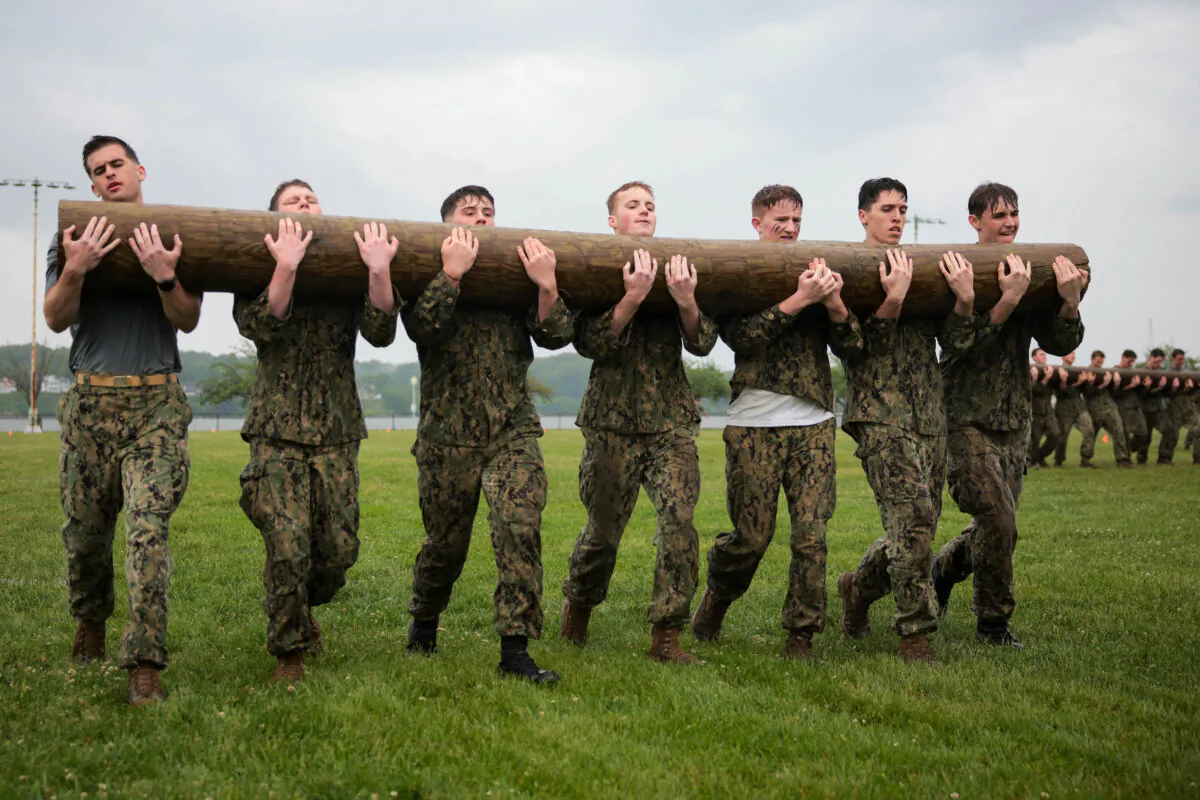 U.S. Naval Academy freshman participate in the log carry portion of the annual Sea Trials at the U.S. Naval Academy in Annapolis, Md., on May 13, 2025. The Sea Trials involve a 14-hour physical and mental challenge modeled after the Marine Corps’ Crucible and the Navy’s Battle Stations recruit programs. (Kayla Bartkowski/Getty Images)