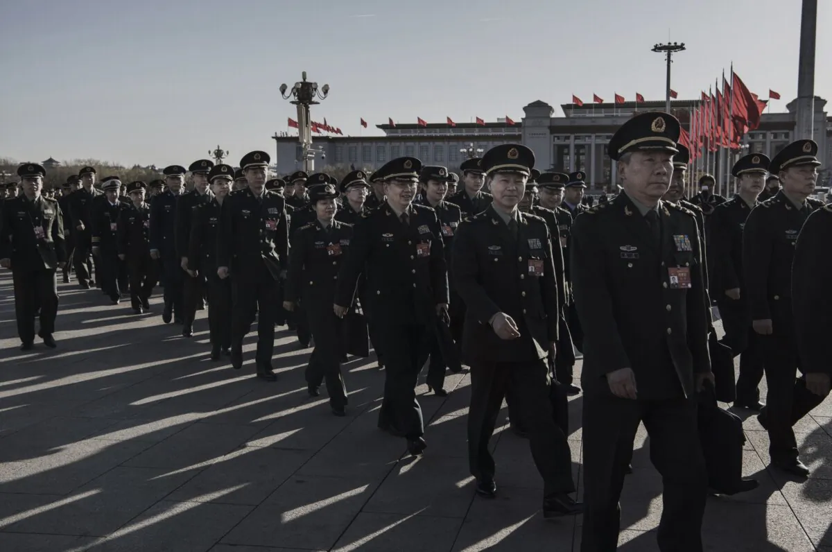 Officers of China's military and police arrive for the third plenary session of China's rubber-stamp legislature, the National People's Congress, in Beijing on March 12, 2019. (Kevin Frayer/Getty Images)
