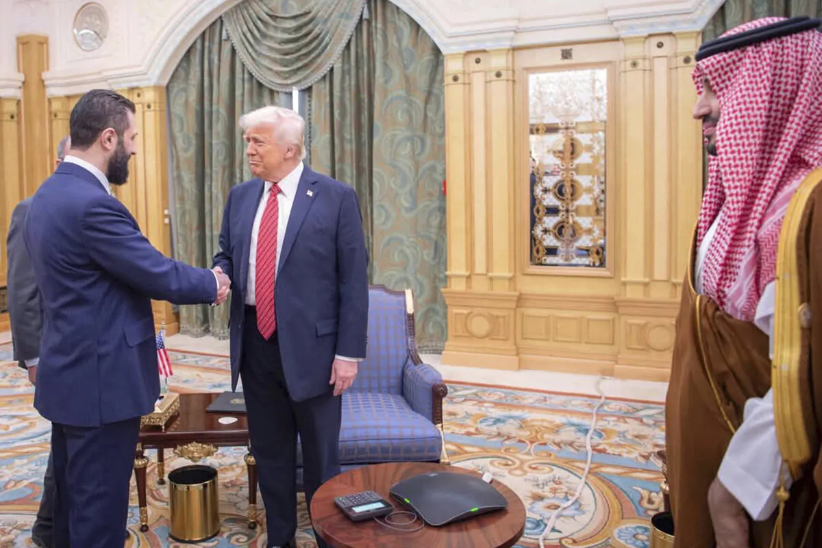 Interim Syrian President Ahmad al-Sharaa (L) shakes hands with U.S. President Donald Trump (C) in Riyadh, Saudi Arabia, on May 14, 2025. At right is Saudi Crown Prince Mohammed bin Salman. (Bandar Aljaloud/Saudi Royal Palace via AP)