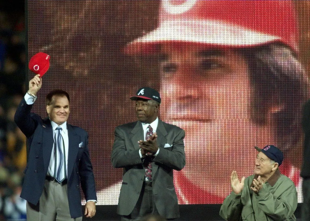 Pete Rose (L) tips his cap after being announced with Henry Aaron (C) and Ted Williams (R) before Game 2 of the 1999 World Series between the New York Yankees and Atlanta Braves at Turner Field in Atlanta, Ga., on Oct. 24, 1999. (Don Emmert/AFP via Getty Images)