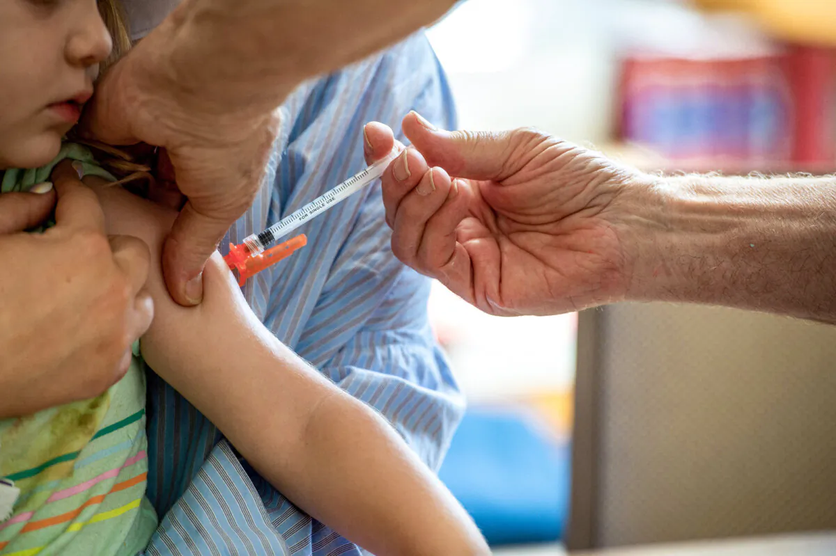 A young child receives a Moderna COVID-19 vaccination. in Needham, Mass., on June 21, 2022. Those who have been injured by the vaccine are not allowed to be heard. (Joseph Prezioso/AFP via Getty Images)