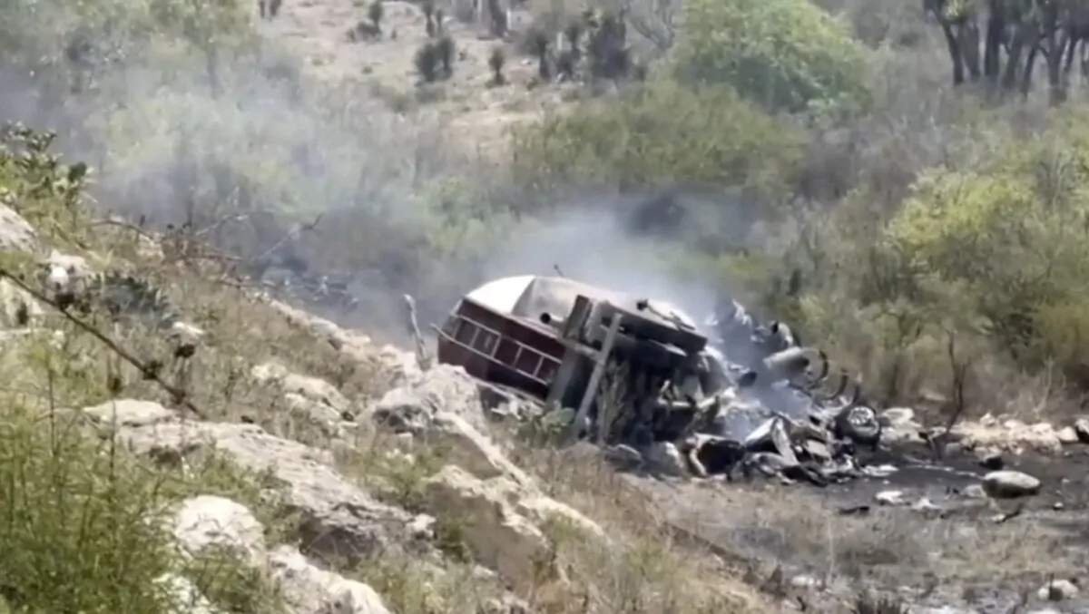 A burnt overturned truck on the side of a road in Puebla, Mexico, on May 14, 2025, in a still from video. (Reuters/Screenshot via The Epoch Times)