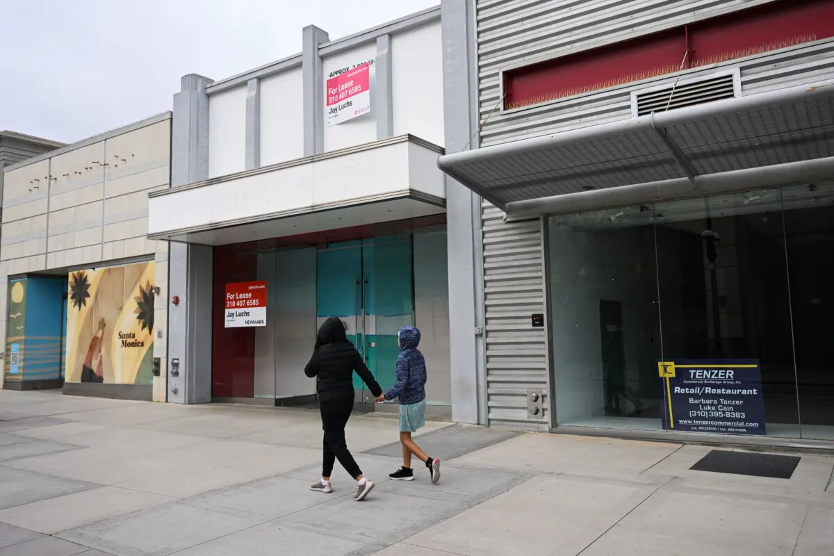 Pedestrians walk past vacant retail store fronts for lease along the Third Street Promenade in Santa Monica, Calif., on March 20, 2023. (Patrick T. Fallon/AFP via Getty Images)