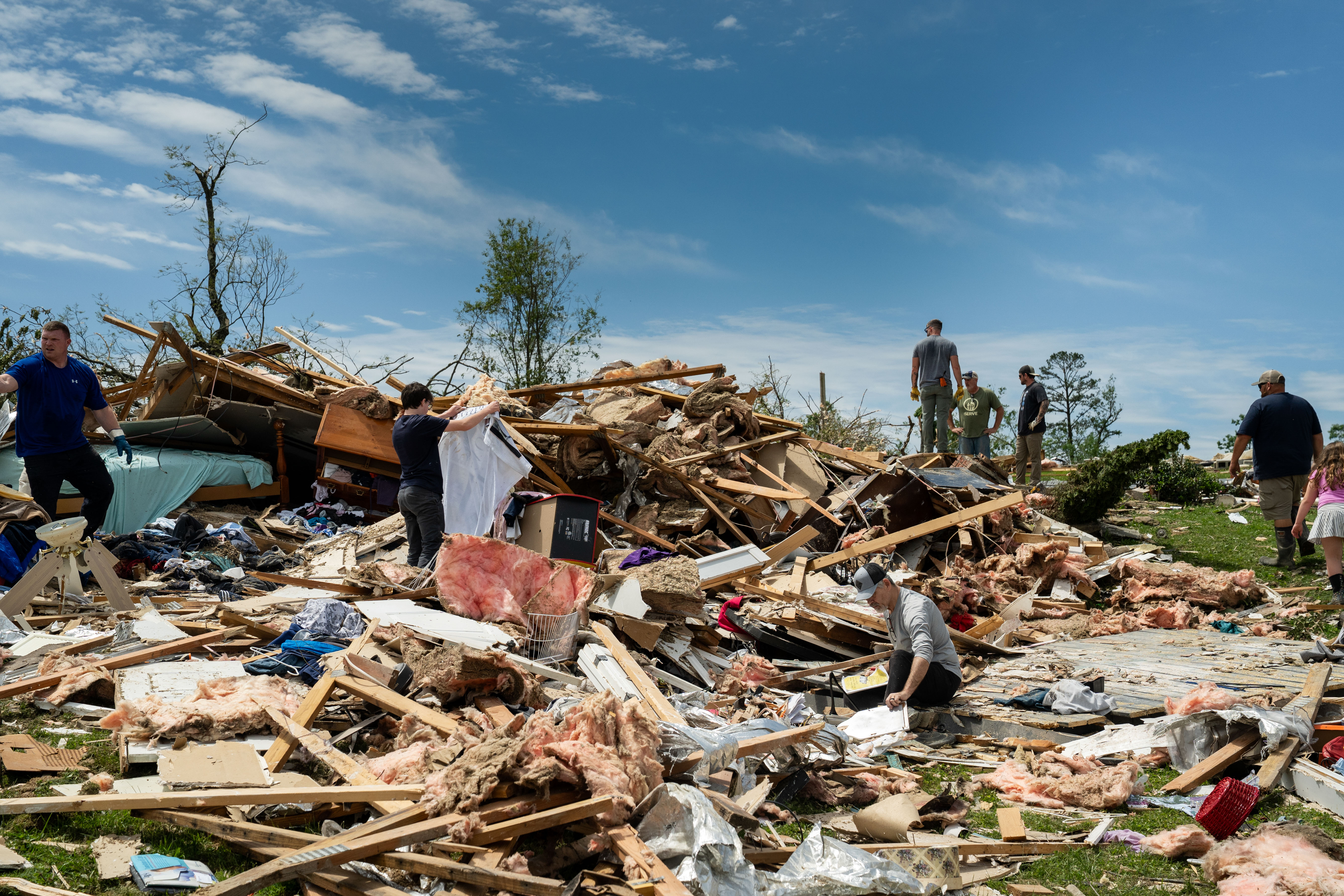 Day in Photos: Tornado Aftermath, Somali Suicide Bomber, and Pig and Run Race