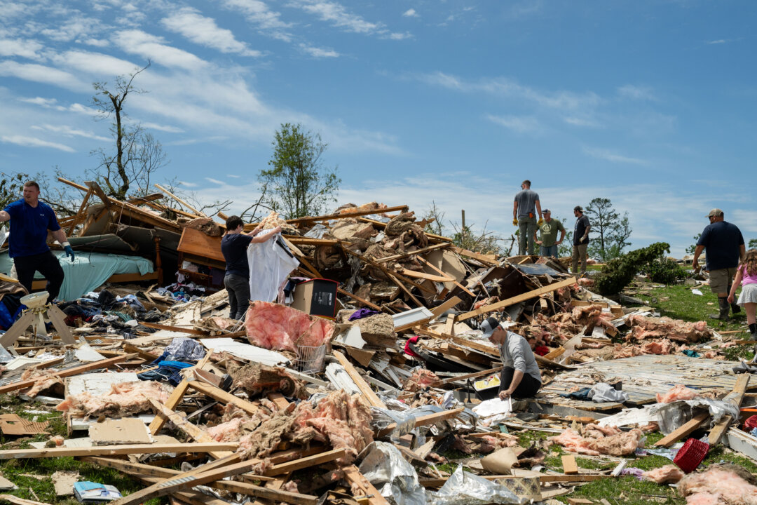 NextImg:Day in Photos: Tornado Aftermath, Somali Suicide Bomber, and Pig and Run Race