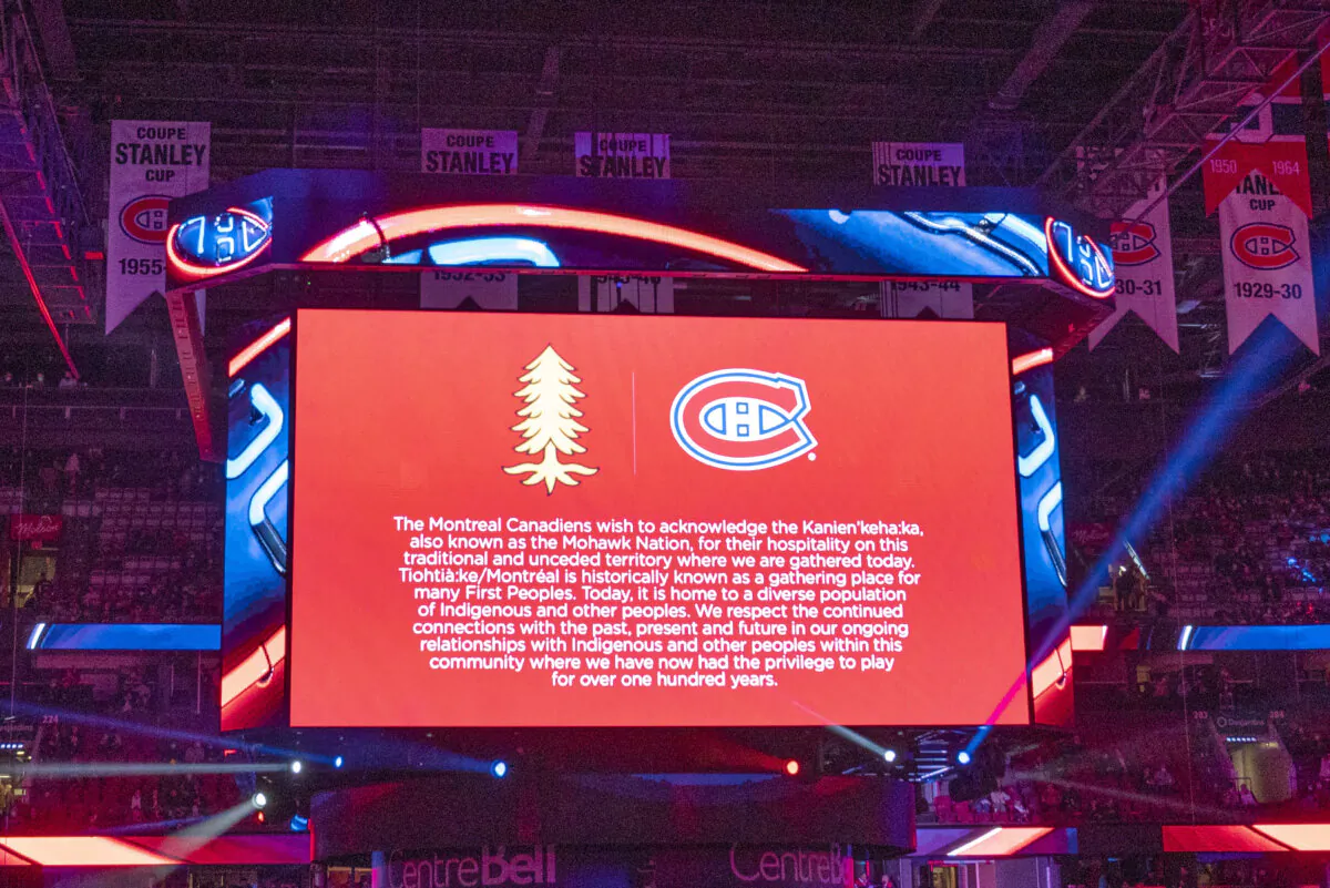 A scoreboard shows a message declaring an indigenous land acknowledgement before an NHL hockey game between the Montreal Canadiens and the San Jose Sharks in Montreal on Oct. 19, 2021. (The Canadian Press/Ryan Remior)
