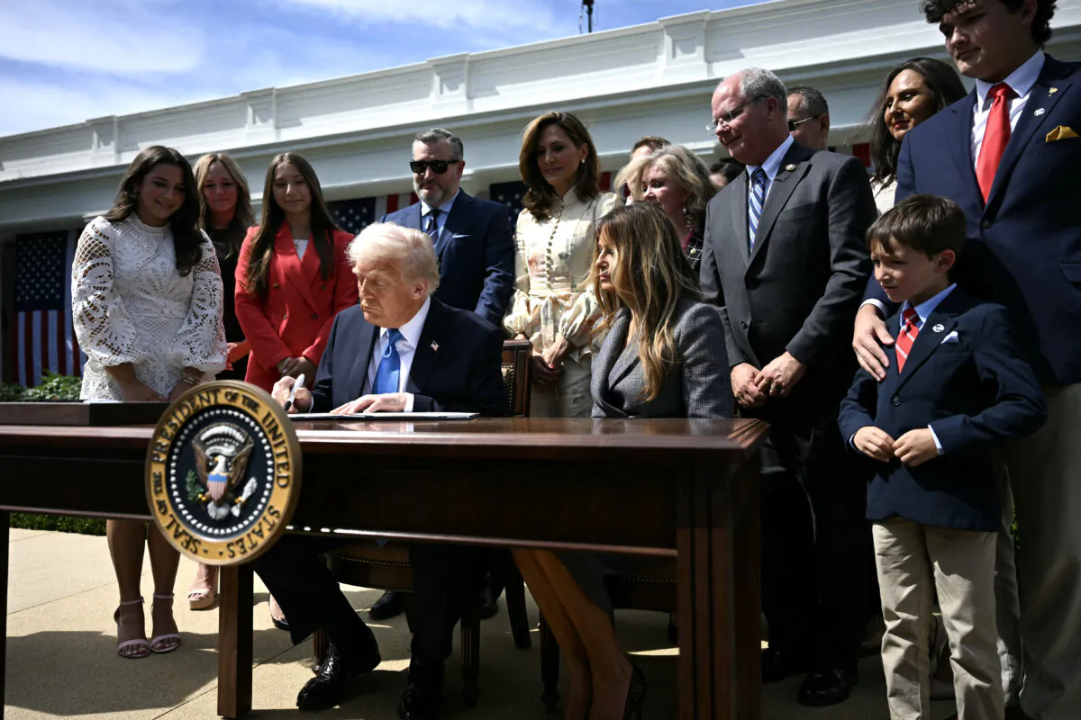 President Donald Trump, alongside First Lady Melania Trump, signs the "Take It Down Act" during a bill signing ceremony in the Rose Garden of the White House on May 19, 2025. (Jim Watson/AFP via Getty Images)