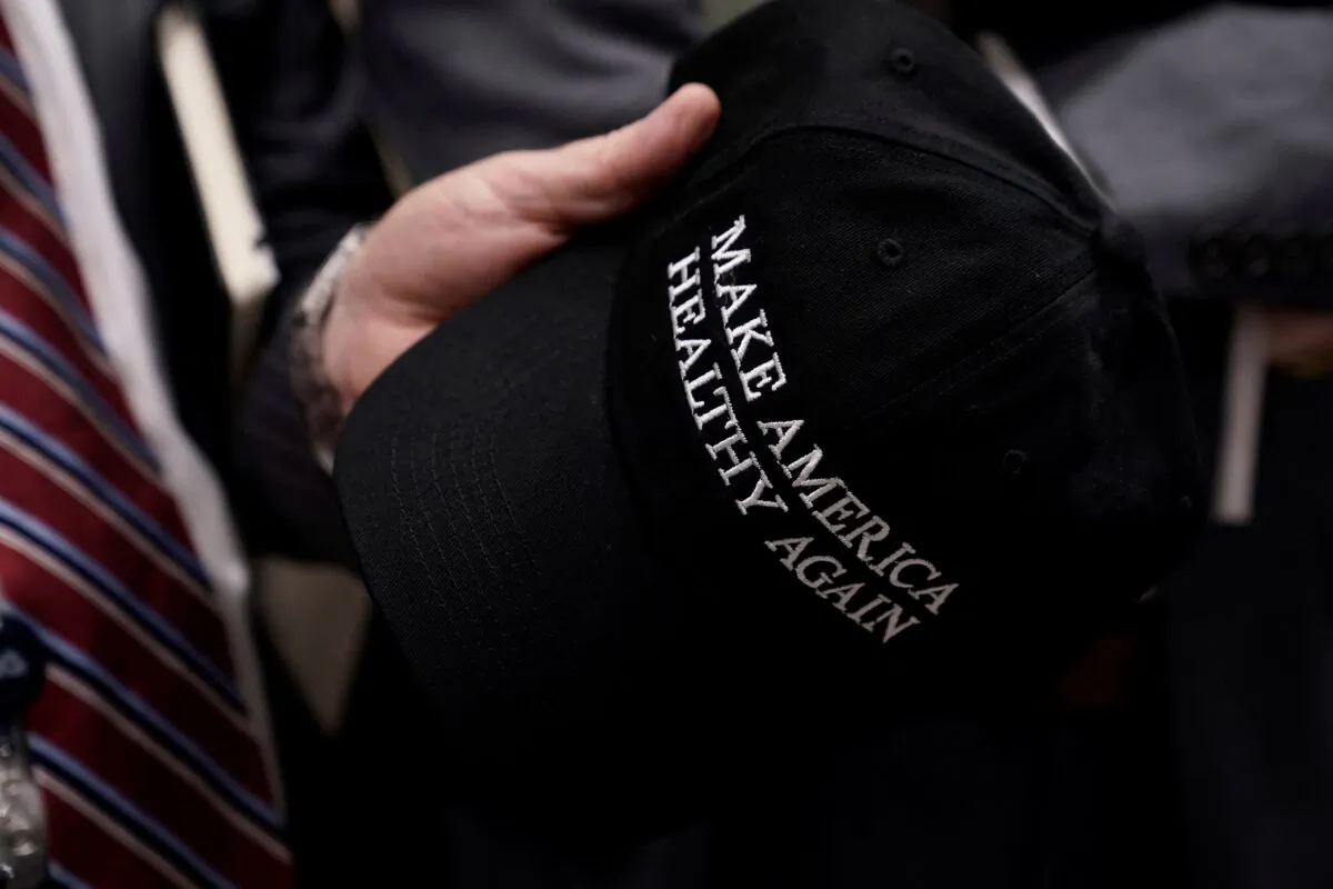 A man holds a hat reading "Make America Healthy Again" at a press conference with Secretary of Health and Human Services Robert F. Kennedy Jr. and Food and Drug Administration Commissioner Martin Makary at the Department of Health and Human Services in Washington on April 22, 2025. (Oliver Contreras/AFP via Getty Images)