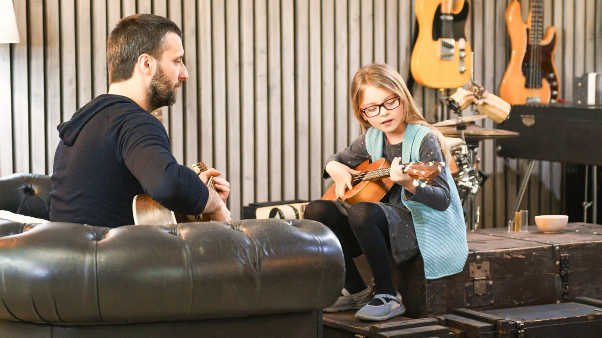 Music becomes a shared language when families learn, play, and make mistakes together. (ZoneCreative/Shutterstock)