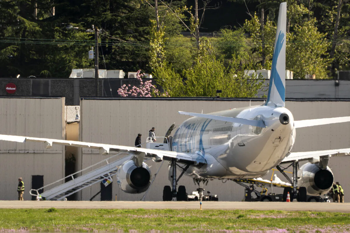 Detainees board a plane chartered by U.S. Immigration and Customs Enforcement at King County International Airport, near Seattle, on April 15, 2025. (David Ryder/Getty Images)