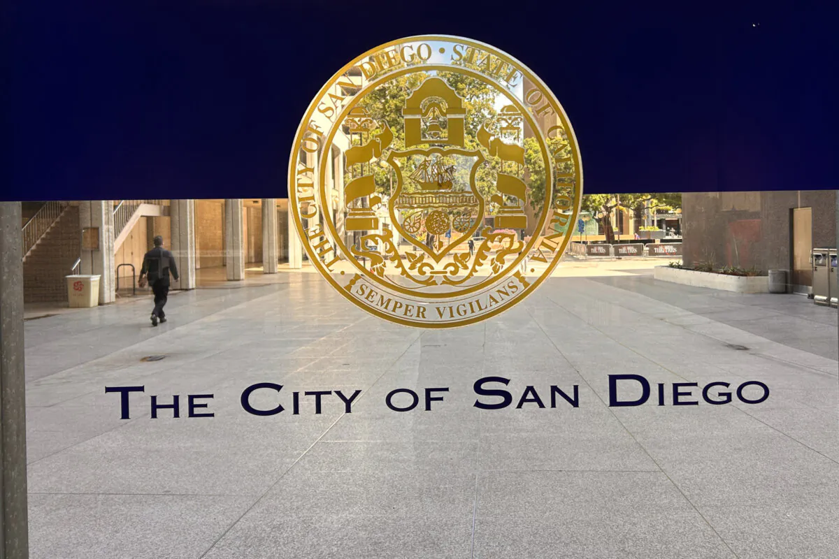City of San Diego emblem on the glass door entrance of the City Administration Building, April 1, 2025. (Jane Yang/The Epoch Times)