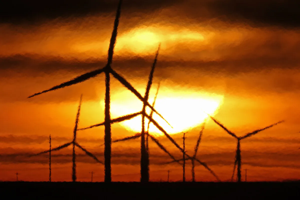 Wind turbines are silhouetted against the rising sun near Spearville, Kansas, on Jan. 13, 2021. (Charlie Riedel/AP Photo)