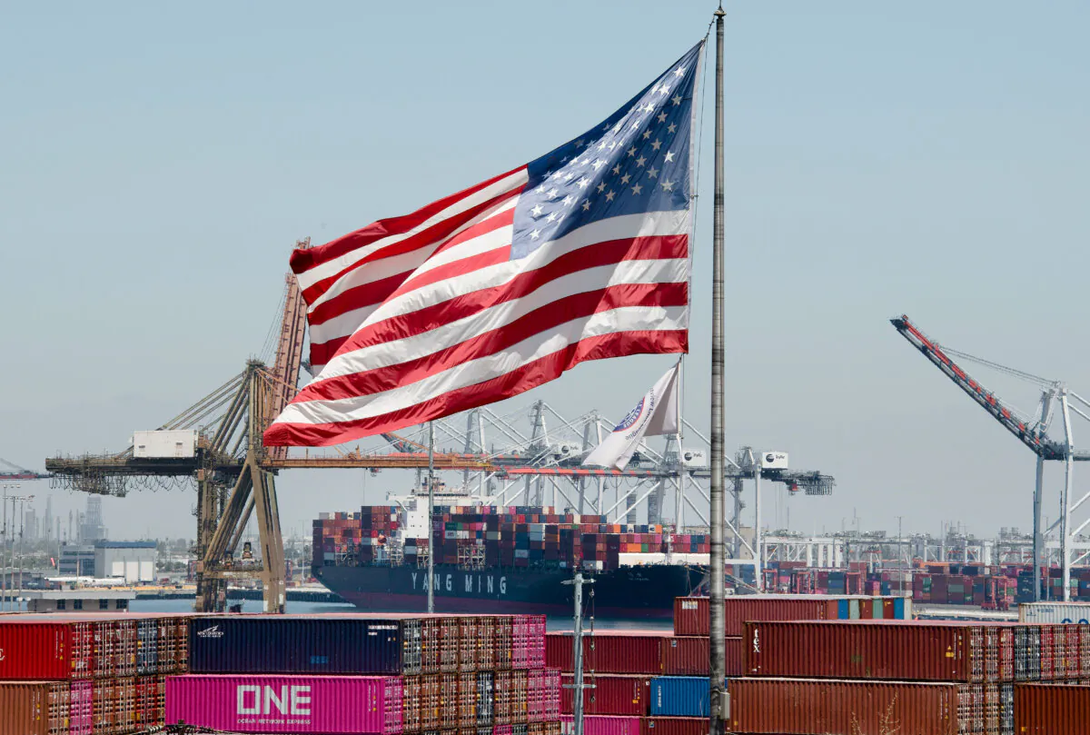 The U.S. flag flies over a container ship unloading cargo from Asia, at the Port of Long Beach, Calif., on Aug. 1, 2019. (Mark Ralston/AFP via Getty Images)