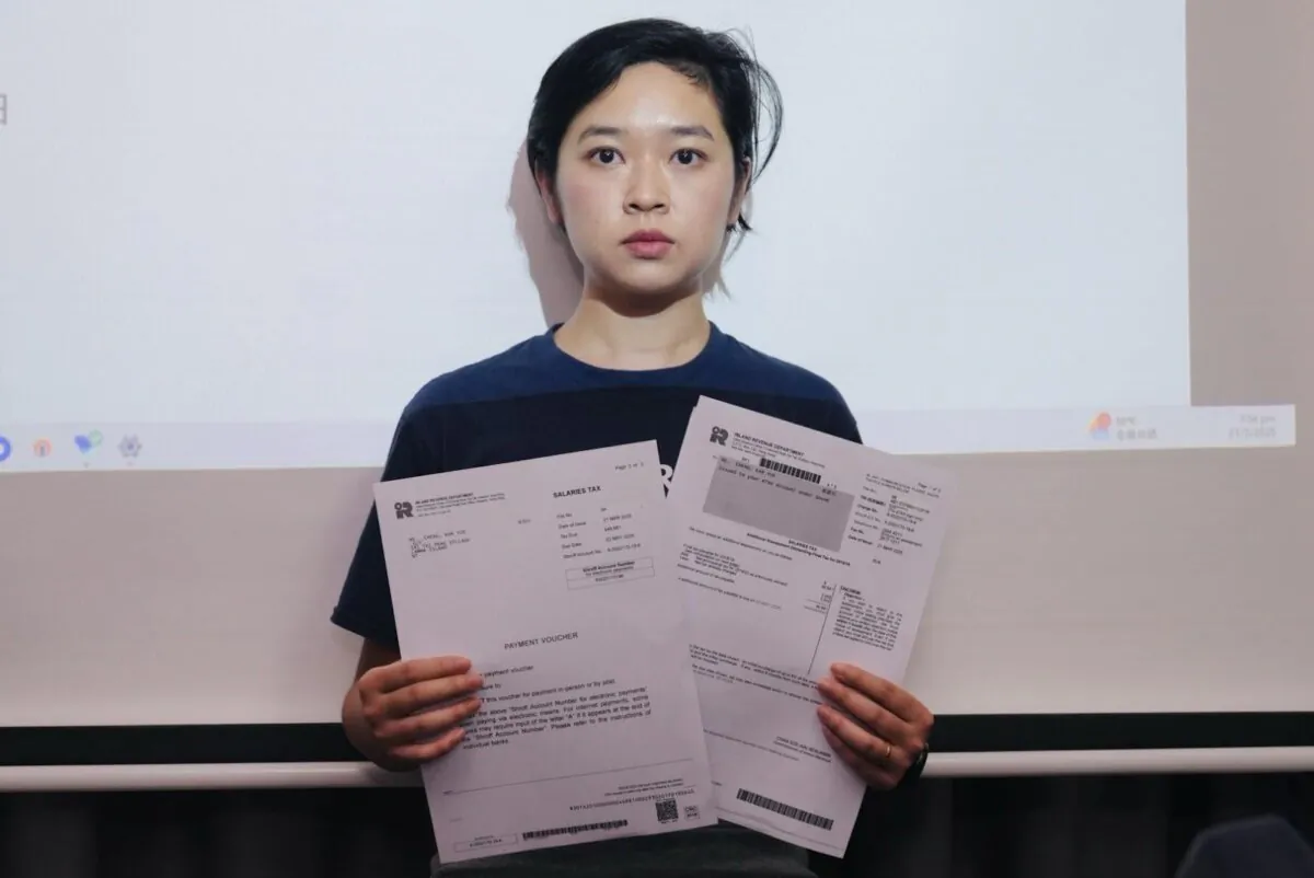 Selina Cheng, chairperson of the Hong Kong Journalists Association (HKJA), holds tax papers at a press conference in Hong Kong on May 21, 2025. (Xiaolong/The Epoch Times)