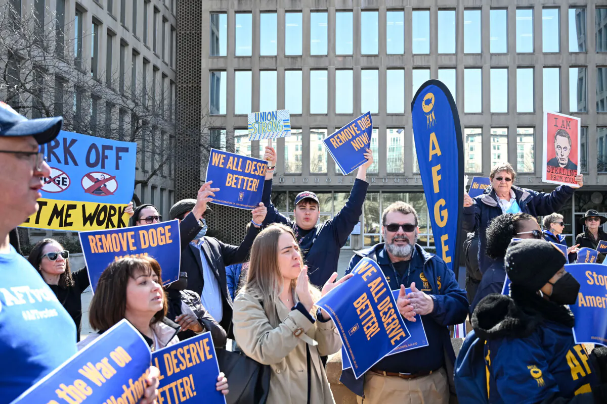 Protesters hold signs in solidarity with the American Federation of Government Employees of District 14 at a rally in support of federal workers at the Office of Personnel Management in Washington on March 4, 2025. (Alex Wroblewski/AFP via Getty Images)
