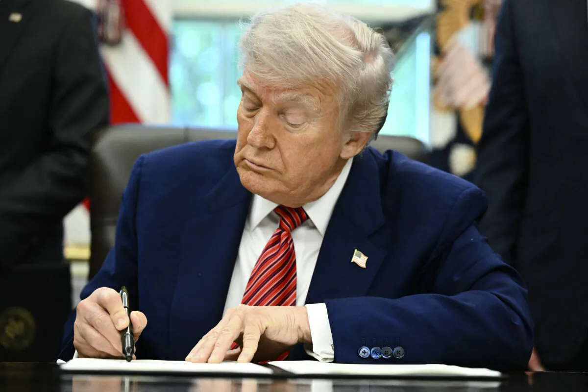 President Donald Trump signs executive orders in the Oval Office of the White House in Washington on May 23, 2025. (Mandel Ngan/AFP via Getty Images)
