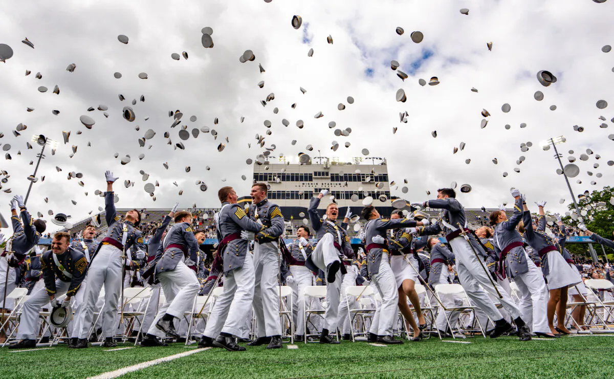 U.S. Military Academy cadets throw their hats at the 2025 graduation ceremony at West Point, N.Y., on May 24, 2025. (Samira Bouaou/The Epoch Times)