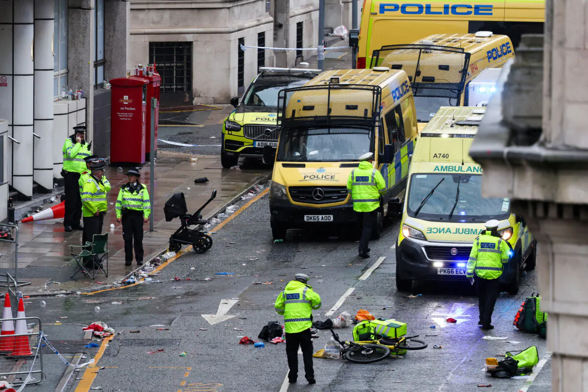 Police officers investigate the scene of an incident in Water Street, on the sidelines of an open-top bus victory parade for Liverpool's Premier League title win, in Liverpool, north-west England, on May 26, 2025. (Darren Staples/AFP via Getty Images)