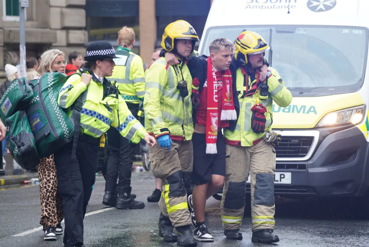 Emergency services help a fan after a car crashed into crowds in Liverpool on May 26, 2025. (Owen Humphreys/PA)