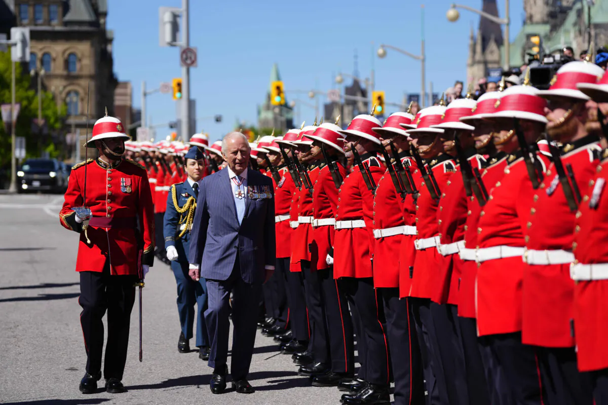 King Charles inspects an honor guard at the Senate of Canada Building in Ottawa during a royal visit on May 27, 2025. (Justin Tang/The Canadian Press)