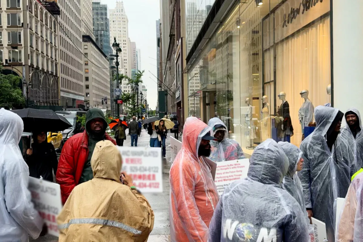 A group of protesters, organized by pro-Chinese Communist Party individuals, try to disrupt a parade held by Falun Gong practitioners in New York City on May 9, 2025. (Editor's note: CCP propaganda text on the signs held by the protesters has been blurred.) (Edwin Huang/The Epoch Times)