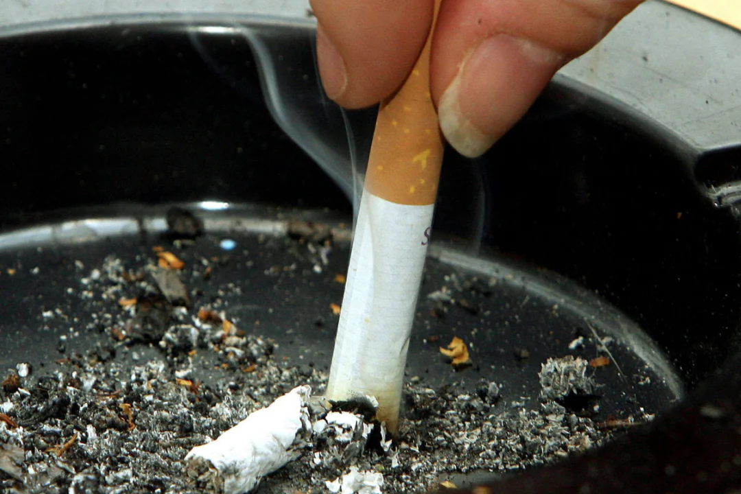 File photo of a smoker stubbing out a cigarette dated Feb. 14, 2006. (Owen Humphreys/PA Wire)
