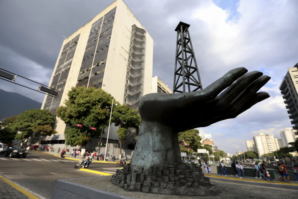 A sculpture of a hand holding an oil drilling rig is pictured outside the state-run oil company Petroleos de Venezuela in Caracas, Venezuela, on Feb. 26, 2025. (Pedro Mattey/AFP via Getty Images)