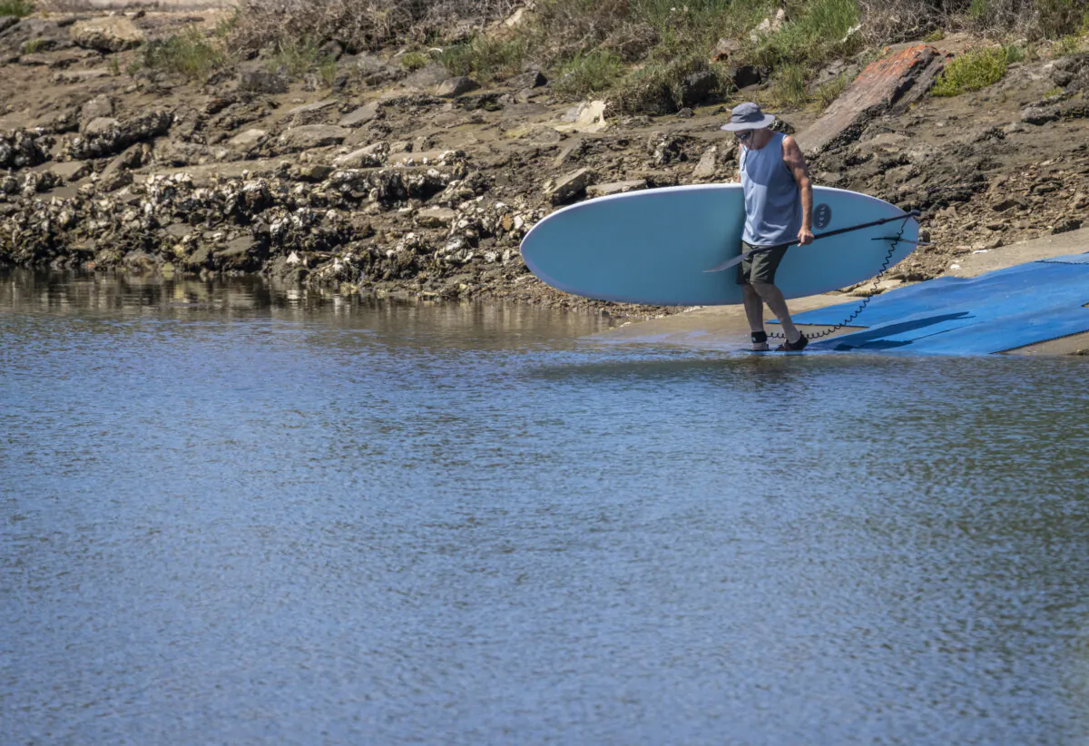 A surfer in San Diego on April 22, 2025. (John Fredricks/The Epoch Times)