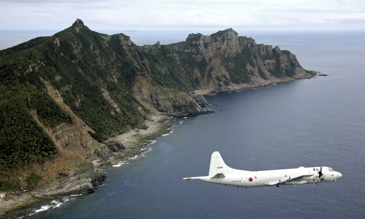 Japan Maritime Self-Defense Force P-3C Orion surveillance plane flies over the disputed islands, called the Senkaku in Japan and Diaoyu in China, in the East China Sea, on Oct. 13, 2011. (Kyodo News via AP Photo)