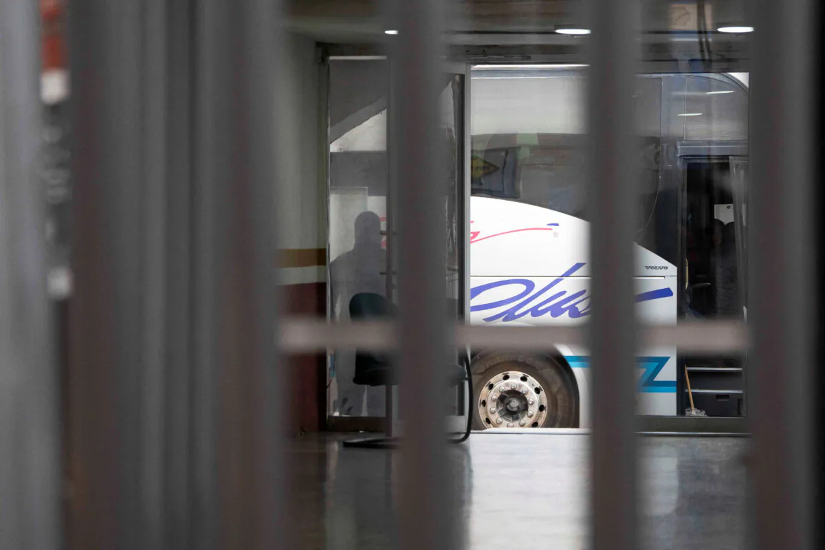 A law enforcement officer surveils a bus used to transport deportees from the United States to Nogales, Sonora, Mexico, Jan. 24, 2025. (Rebecca Noble/File Photo/Reuters)