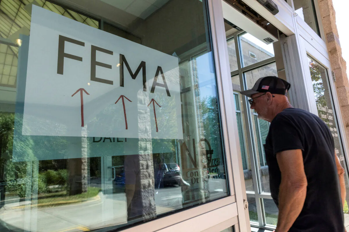 A resident enters a FEMA's improvised station to attend claims by local residents affected by floods following the passing of Hurricane Helene, in Marion, N.C., on Oct. 5, 2024. (Eduardo Munoz/File Photo / Reuters)