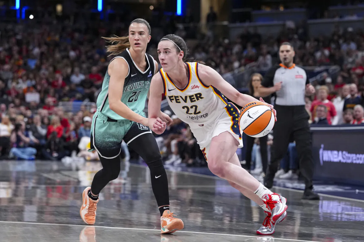 Indiana Fever guard Caitlin Clark (22) drives on New York Liberty guard Sabrina Ionescu (20) in the second half of a WNBA basketball game in Indianapolis on May 24, 2025. (Michael Conroy/AP Photo)
