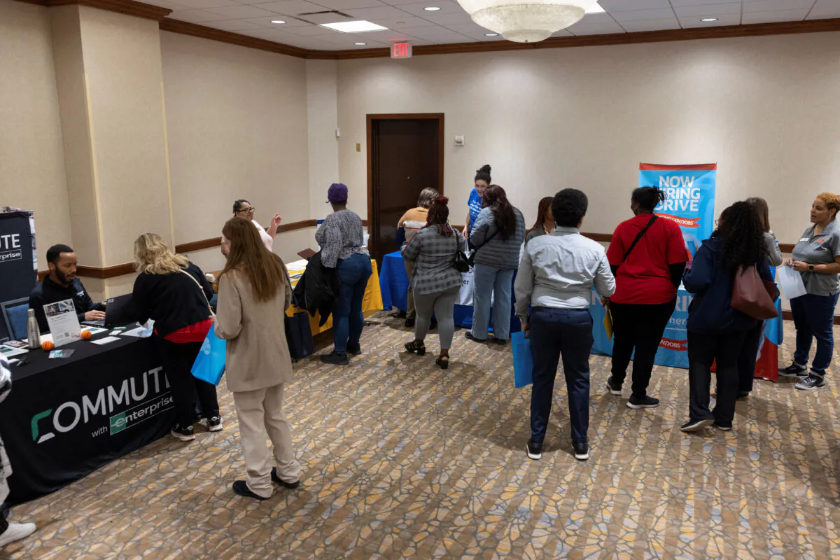 People speak with job placement and professional development representatives during a job fair for federal workers fired in recent weeks through job cuts, organized by the National Treasury Employees Union in Kansas City, Mo., on March 15, 2025. (Chase Castor/Reuters)