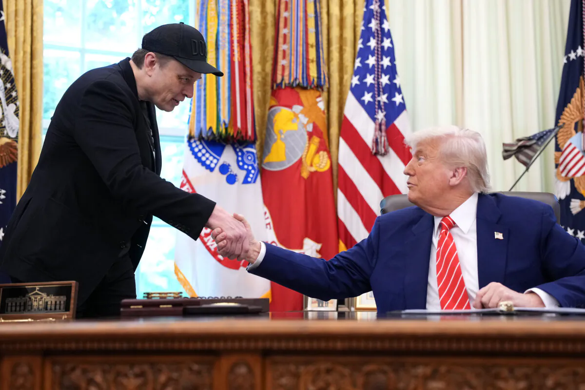 Tesla CEO Elon Musk shakes hands with President Donald Trump as they speak to reporters in the Oval Office of the White House in Washington on May 30, 2025. (Kevin Dietsch/Getty Images)