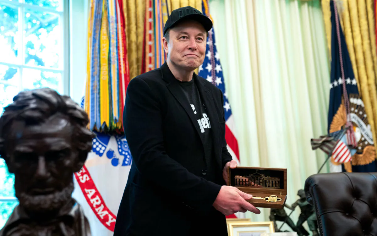 Elon Musk holds a "key to the White House" given to him by  President Trump  during a news conference in the Oval Office on May 30, 2025.  (Allison Robbert/AFP)