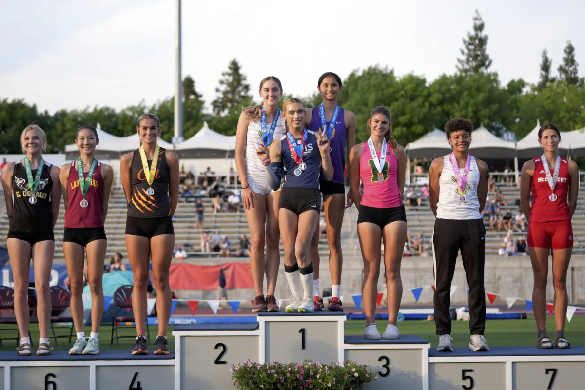 AB Hernandez (C) shares the first-place spot on the podium with Jillene Wetteland (L) and Lelani Laruelle during a medal ceremony for the high jump at the California high school track-and-field championships in Clovis, Calif., on May 31, 2025. (AP Photo/Jae C. Hong)