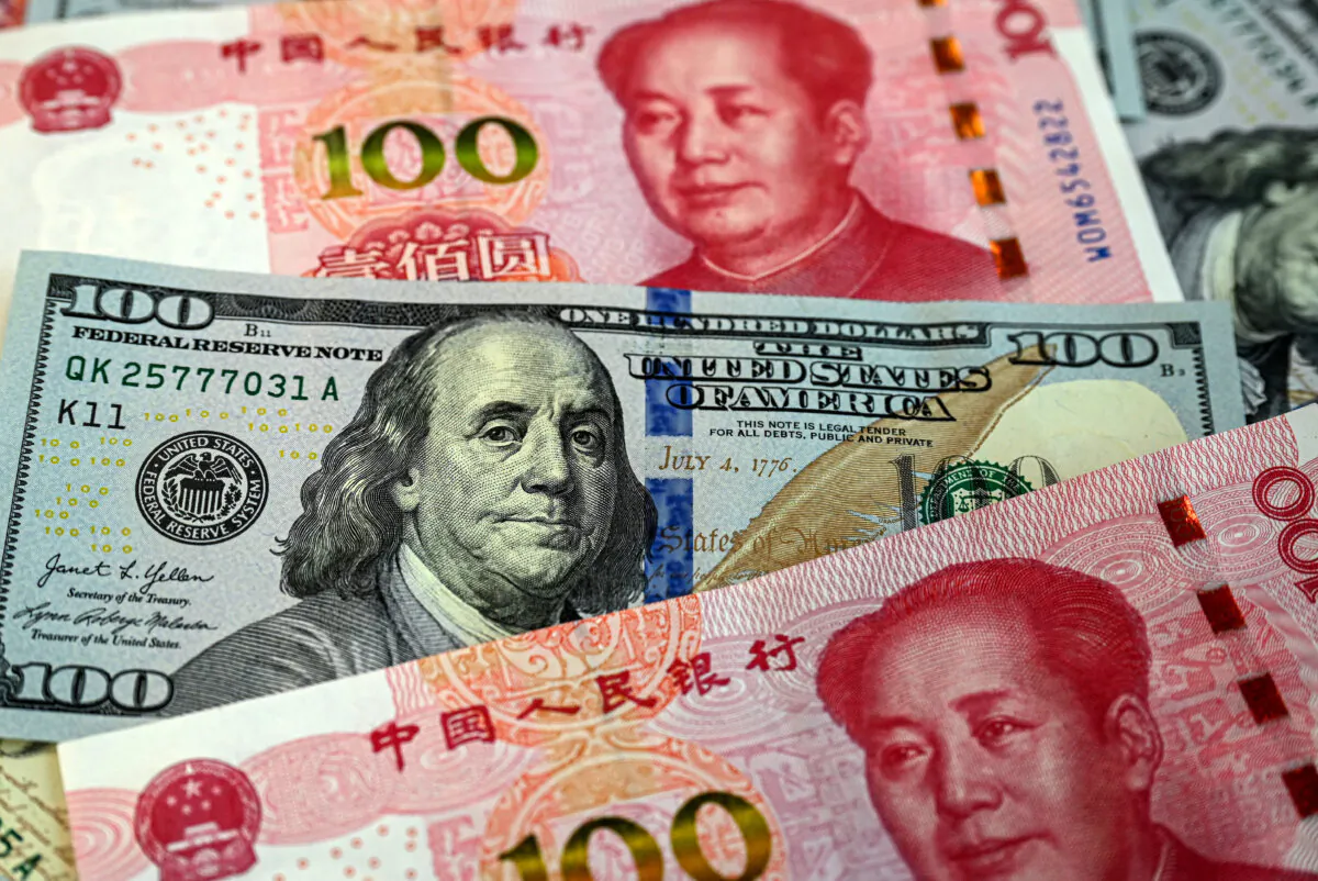 This photo illustration shows Chinese 100 yuan notes (red) and US$100 notes, in Beijing, on April 8, 2025. (Jade Gao /AFP via Getty Images)