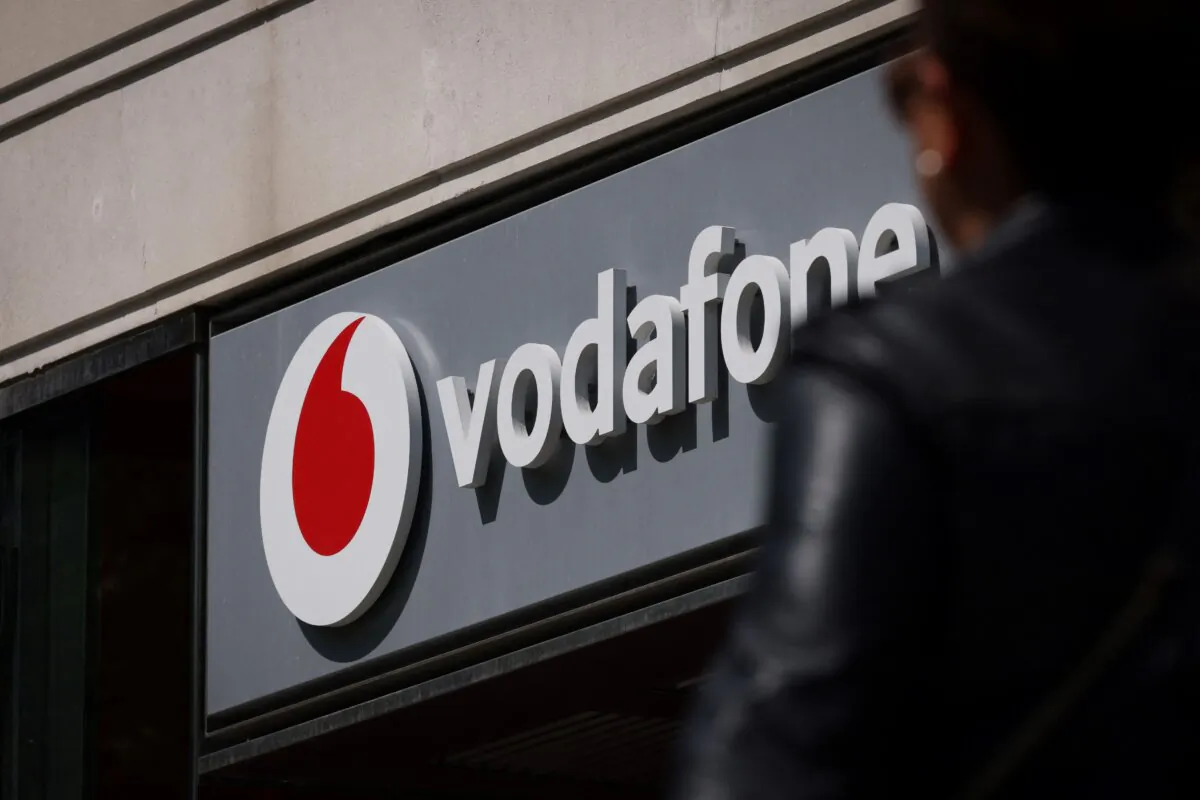 A pedestrian walks past a Vodafone store in central London on May 16, 2023. (Adrian Dennis/AFP via Getty Images)