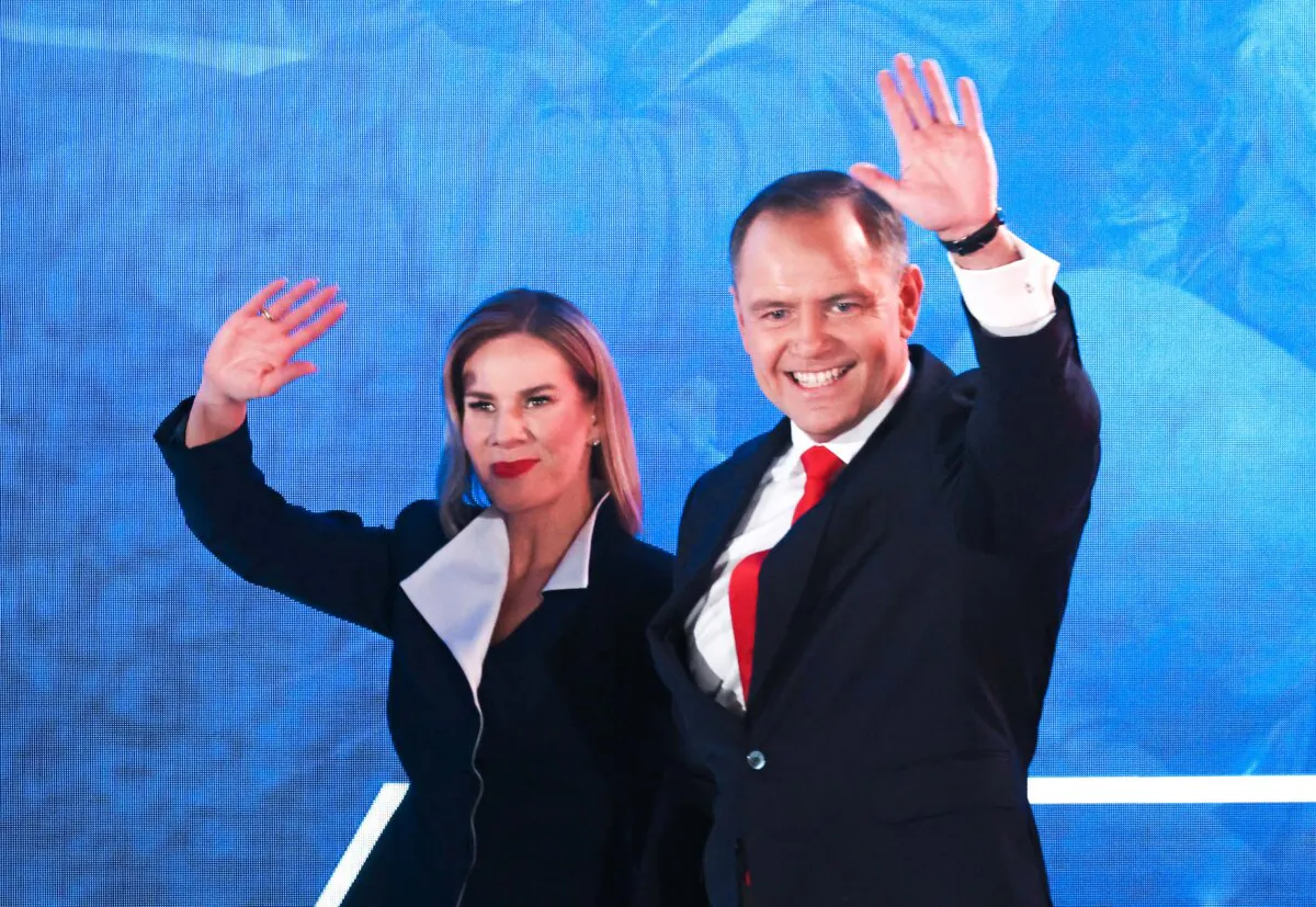 Karol Nawrocki, presidential candidate of the Law and Justice Party (PiS), and his wife Marta arrive to greet supporters following the Polish presidential runoff election in Warsaw, Poland, on June 1, 2025. (Sean Gallup/Getty Images)