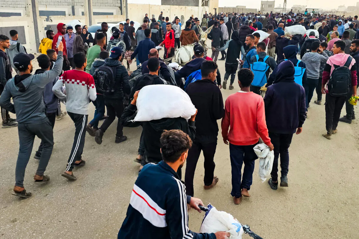 Displaced Palestinians, some carrying sacks of food, leave a distribution centre in Rafah, in the southern Gaza Strip, on June 1, 2025. (AFP via Getty Images)