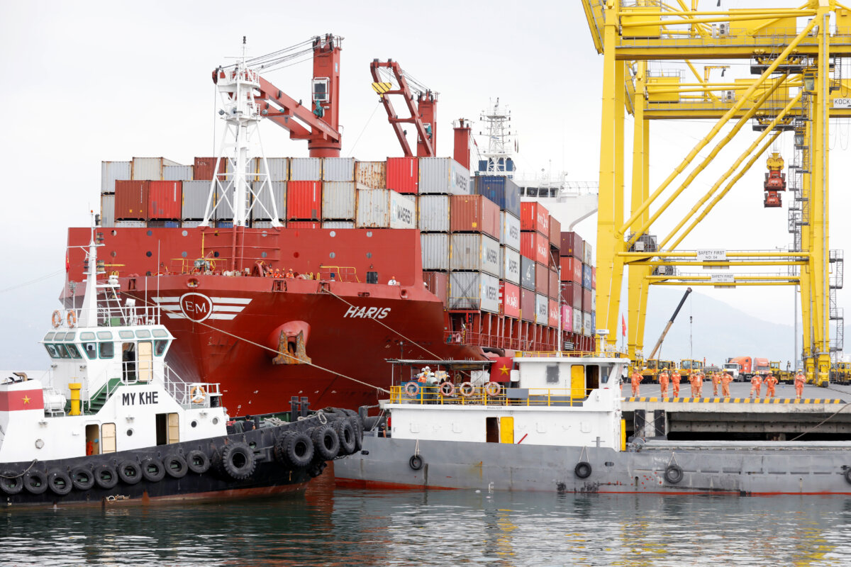 Containers are loaded onto a ship at Tien Sa port in Da Nang city, Vietnam, on March 6, 2020. (Kham/Reuters)