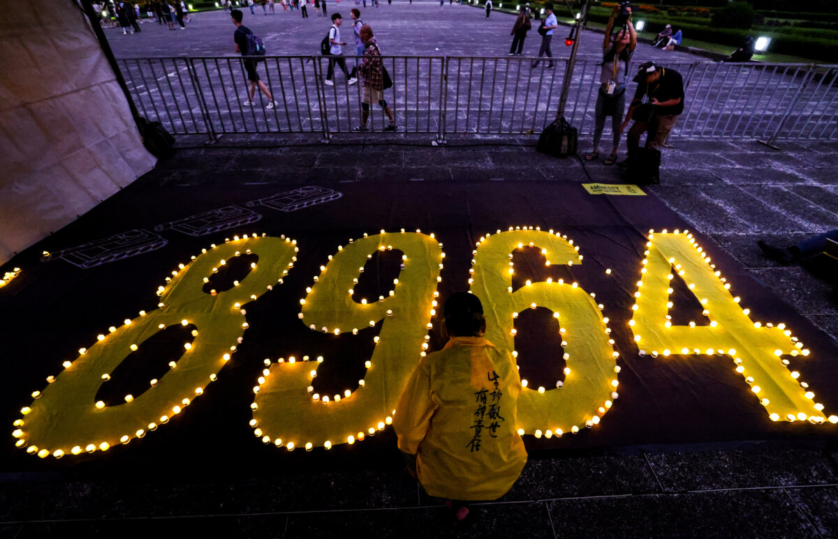 A man places a candle at Liberty Square to mark the 36th anniversary of China's Tiananmen Square crackdown on pro-democracy demonstrators in 1989, in Taipei, Taiwan, on June 4, 2025. (I-Hwa Cheng/AFP via Getty Images)