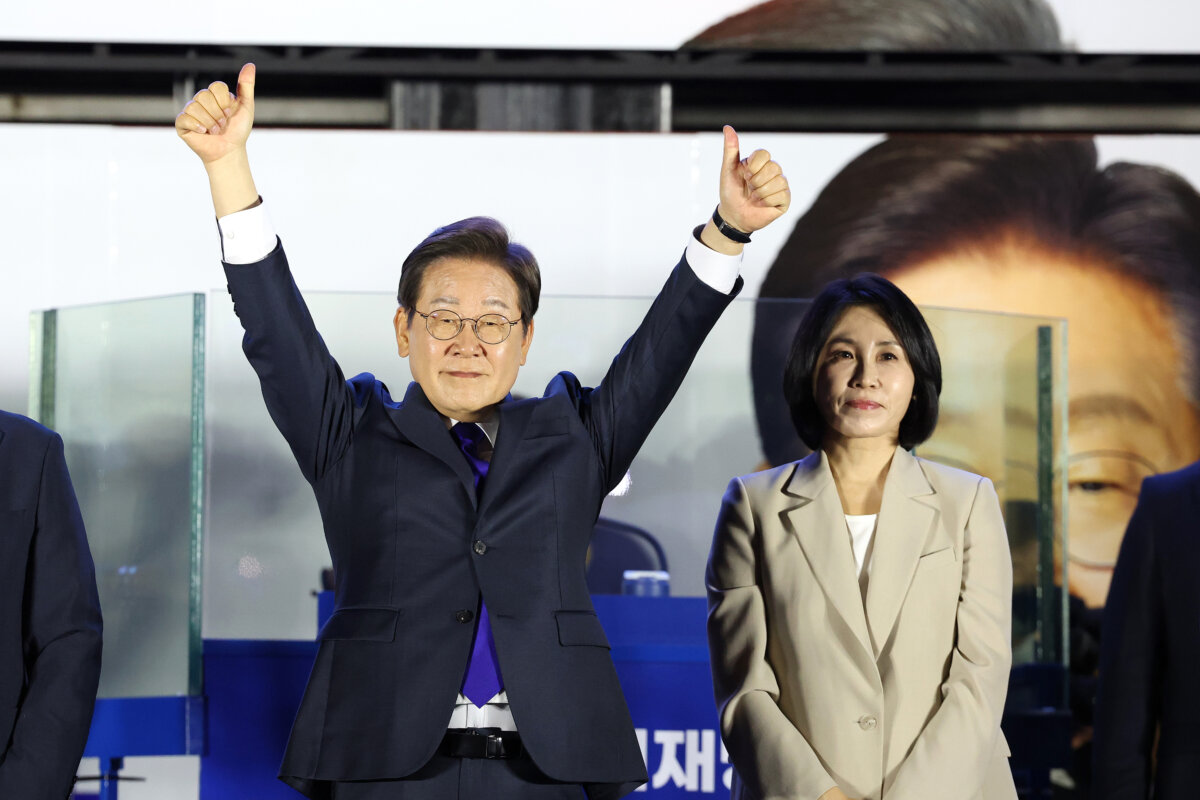 Lee Jae-myung, the presidential candidate of the Democratic Party, and his wife, Kim Hea-Kyung, celebrate in front of the National Assembly in Seoul, South Korea, on June 4, 2025. (Chung Sung-Jun/Getty Images)