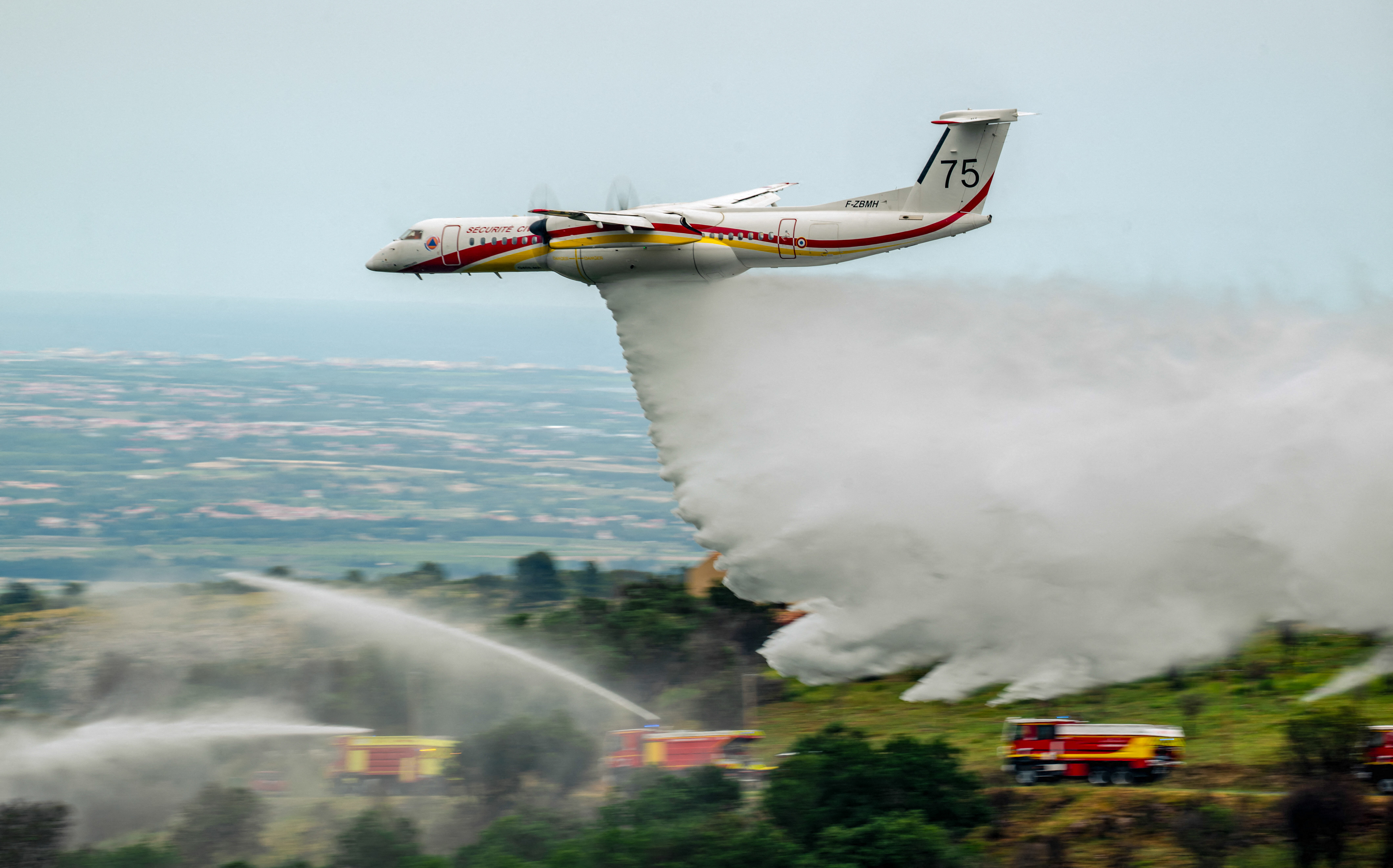 Day in Photos: Firefighting Demonstration, Casting Ballots in Burundi, and Gendarme Dog